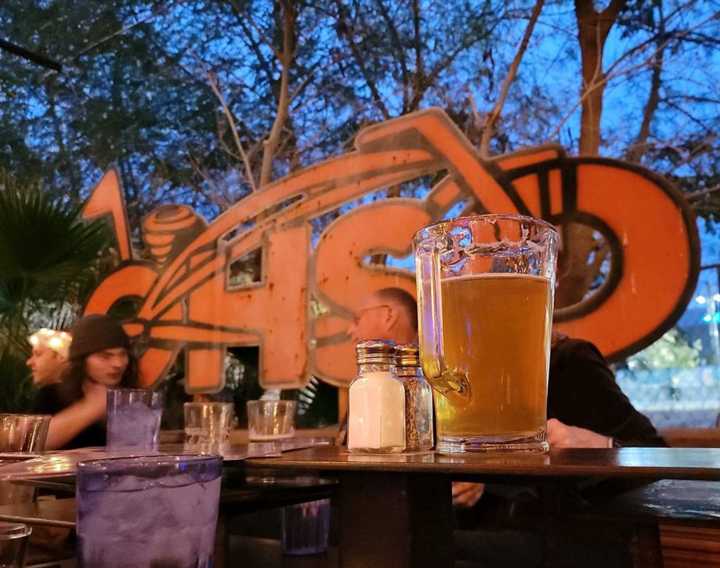 Pitcher of beer in front of OHSO sign
